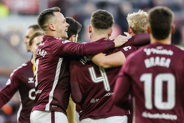Craig Halkett is mobbed by his teammates after Hearts' win over Livingston.