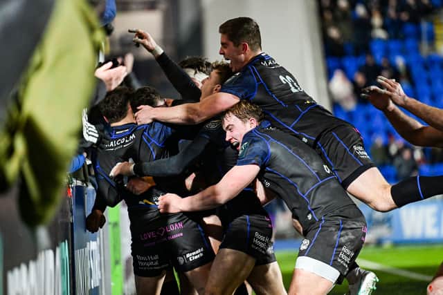Duncan Weir is mobbed by his Glasgow Warriors teammates after scoring a late try.