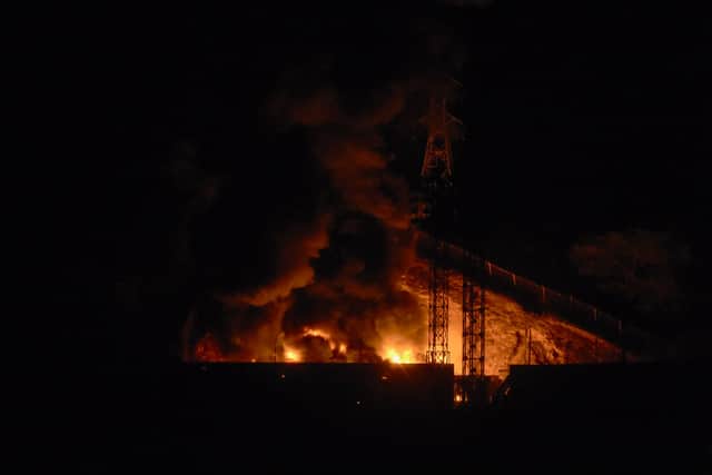 TOPSHOT - Picture of fire at Fuerte Tiuna, Venezuela's largest military complex, after a series of explosions in Caracas on January 3, 2026. Loud explosions, accompanied by sounds resembling aircraft flyovers, were heard in Caracas around 2:00 am (0600 GMT) on January 3, an AFP journalist reported. The explosions come as US President Donald Trump, who has deployed a navy task force to the Caribbean, raised the possibility of ground strikes against Venezuela. (Photo by Luis JAIMES / AFP via Getty Images)