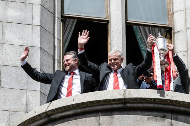 Aberdeen manager Jimmy Thelin (L) and chairman Dave Cormack celebrate the Scottish Cup win on the town hall balcony. (Photo by Paul Devlin / SNS Group)