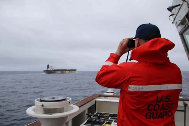 A member of the US Coast Guard observes the tanker. Picture: @US_EUCOM/X/PA Wire