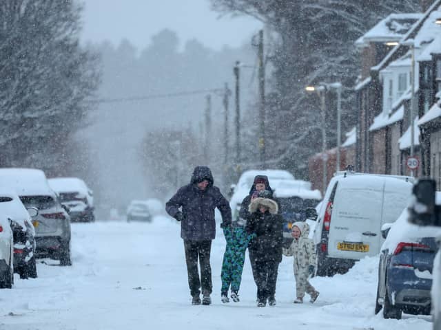 Family walking in the snow in Ballater