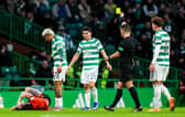 Referee Nick Walsh shows a yellow card to Celtic's Julian Araujo after a tackle on Dundee United's Will Ferry. (Photo by Craig Foy / SNS Group)