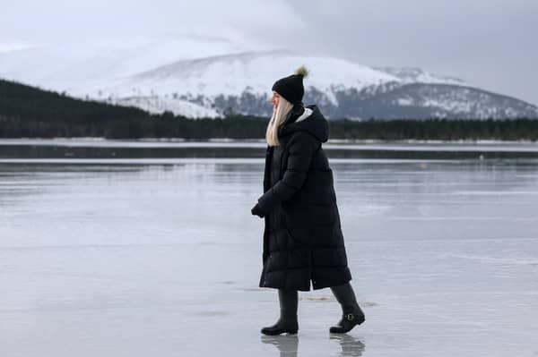 A member of the public walks on a frozen Loch Morlich near Aviemore but as ice melts in other parts of the country, the risk of flooding has increased. PIC: Jeff J Mitchell/Getty