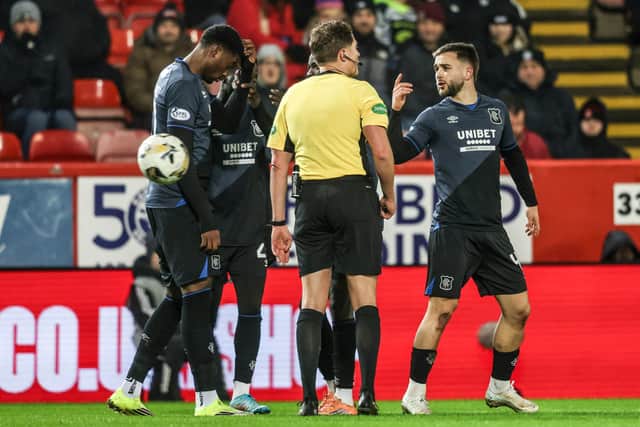 Rangers' Nicolas Raskin (R) speaks to referee David Dickinson after Emmanuel Fernandez is struck by an object.