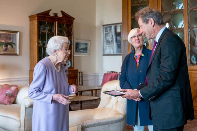 John Wallace receiving Her Majesty's Medal for Music from Queen Elizabeth II in 2022.