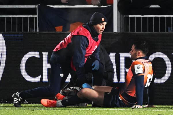 Edinburgh's Matt Currie goes down injured during the Investec Champions Cup match against Gloucester at Hive Stadium.