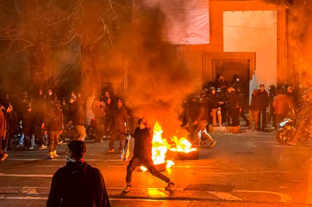 Iranian anti-government protesters block a street during a demonstration in Tehran last week (Picture: MAHSA)