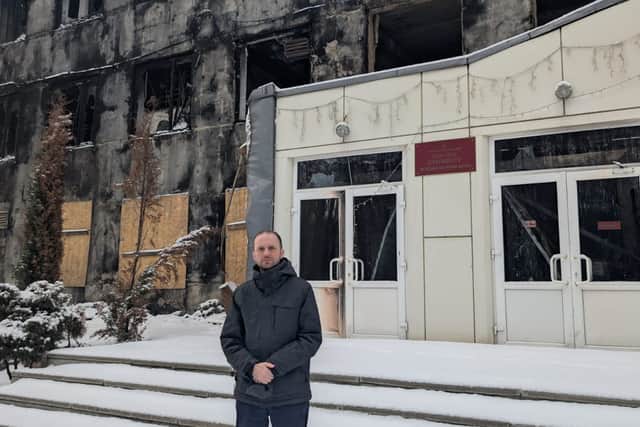 Stephen Gethins stands outside a school in Sumy, Ukraine, destroyed by Russian missiles