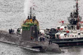 A submarine is manoeuvred at His Majesty's Naval Base Clyde in Faslane