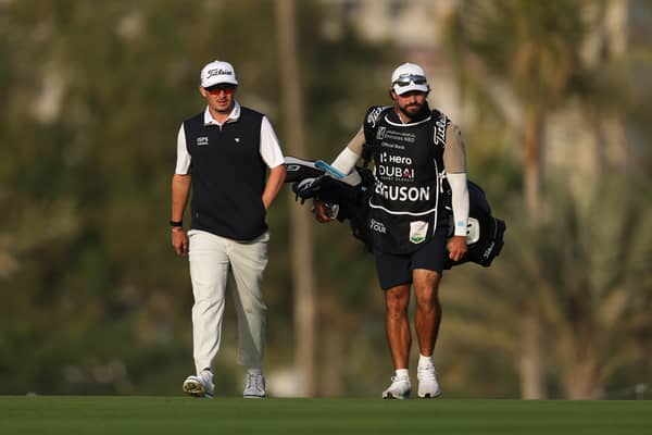 Ewen Ferguson  walks with his caddie Lyle Phillips on day two of the Hero Dubai Desert Classic at Emirates Golf Club 