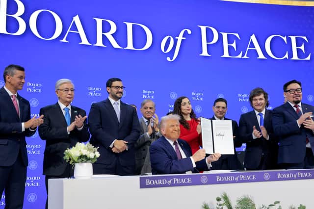 Donald Trump holds up his signature on the founding charter of his new Board of Peace, as the leaders of countries including Paraguay, Kazakhstan and Argentina look on (Picture: Chip Somodevilla)