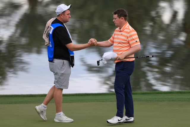 Bob MacIntyre shake hands with caddie Mike Burrow at the end of an impressive opening round in The American Express at La Quinta in California