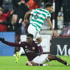 Celtic's Auston Trusty fouls Hearts' Pierre Landry Kabore which results in him being sent off after a VAR check confirmed the denial of a goal scoring opportunity. (Photo by Ross Parker / SNS Group)