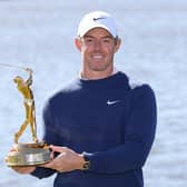 Rory McIlroy poses with the trophy after winning The Players Championship last year 