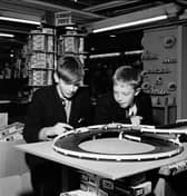 Schoolboys play with a slot-car racing set called Trix in the toy section of Binns department store, Edinburgh, in November 1965