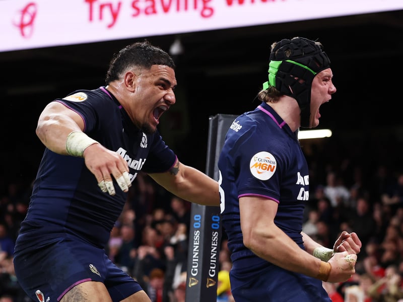 Darcy Graham of Scotland celebrates scoring his team's third try with teammate Sione Tuipulotu.