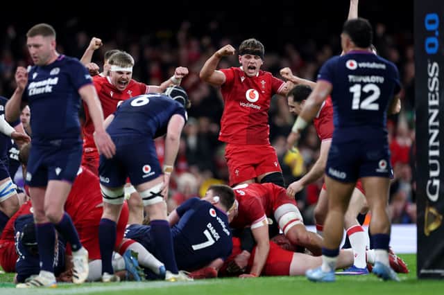Wales celebrate after Rhys Carre of Wales (obscured) scores his team's first try against Scotland. (Photo by Dan Istitene/Getty Images)