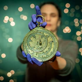 Dr Rebekah Higgitt of National Museums Scotland examines an 11th century astronomical instrument known as an astrolabe on the 1000th anniversary of its manufacture. 