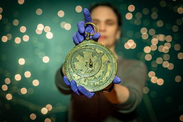 Dr Rebekah Higgitt of National Museums Scotland examines an 11th century astronomical instrument known as an astrolabe on the 1000th anniversary of its manufacture.