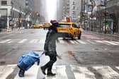 A woman crosses Third Avenue in the Manhattan borough of New York City on Sunday