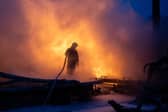 A Ukrainian emergency worker tries to extinguish a fire following Russian missile strikes on Kyiv last month (Picture: Oleksandr Magula)
