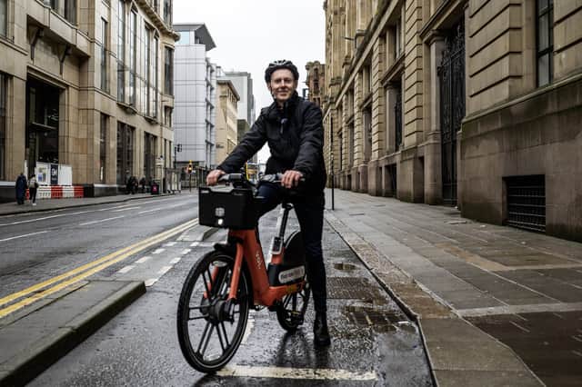 The Scotsman Transport Correspondent Alastair Dalton on a Voi electric hire bike on Waterloo Street in Glasgow city centre