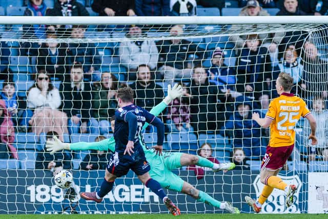 Finlay Robertson fires home the winner for Dundee against Motherwell.