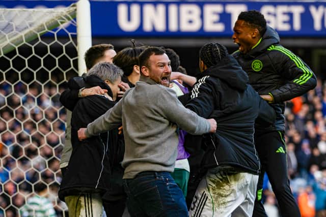 Celtic fans enter the field of play to celebrate with the team after the penalty shootout win vs Rangers.