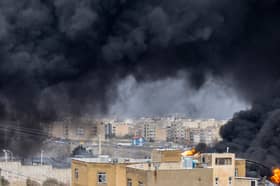 Smoke billows after airstrikes on oil depots on Sunday in Tehran, Iran