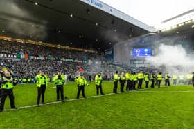 Police form a barricade to stop and block fans getting onto the pitch after the Scottish Cup quarter-final between Rangers and Celtic at Ibrox Stadium. (Photo by Craig Williamson / SNS Group)