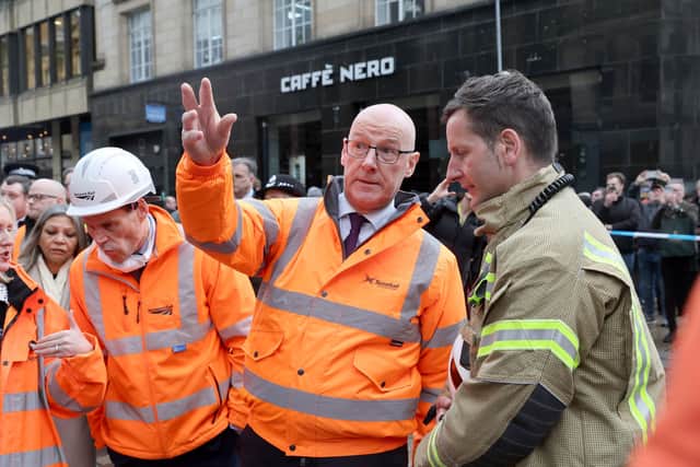 John Swinney speaking to firefighters at the scene of the fire in Glasgow city centre