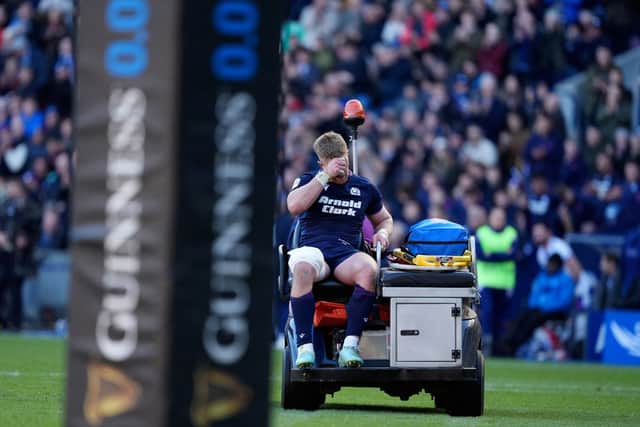 Scotland's Kyle Steyn leaves the field after picking up a gash to his leg while trying in vain to stop France's Antoine Dupont scoring a try.
