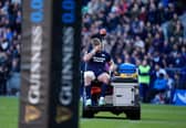 Scotland's Kyle Steyn leaves the field after picking up a gash to his leg while trying in vain to stop France's Antoine Dupont scoring a try.