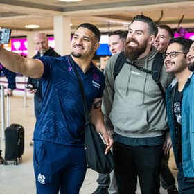 Scotland captain Sione Tuipulotu with supporters at Edinburgh airport ahead of the squad's departure for Dublin for their final Six Nations fixture, against Ireland.