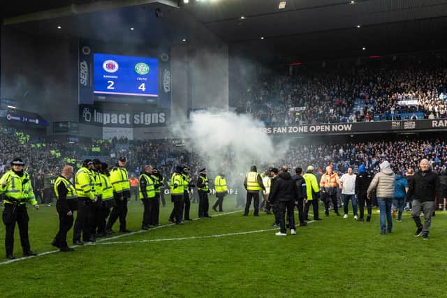 Police line up to block fans from storming the pitch during last weekend's Scottish Cup Old Firm derby between Rangers and Celtic at Ibrox.