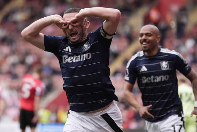 John McGinn celebrates a goal for Aston Villa.
