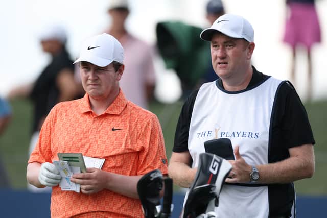 Bob MacIntyre and caddie Mike Burrow talk tactics during the last round of The Players Championship
