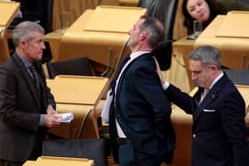 Liam McArthur MSP is consoled by Willie Rennie and Alex Cole-Hamilton after MSPs voted against the Assisted Dying Bill (Picture: Jeff J Mitchell)