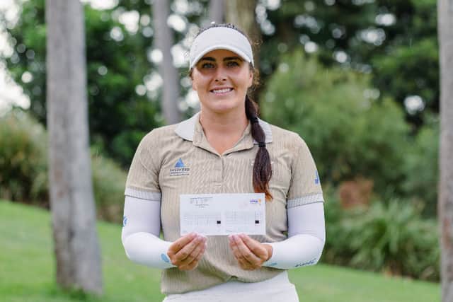 Kelsey MacDonald shows off her course-record card at Sanctuary Cove Golf & Country Club