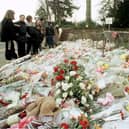 The flowers massed at the gates of Dunblane Primary School following the shooting of teacher Gwen Mayor and sixteen young children in 1996