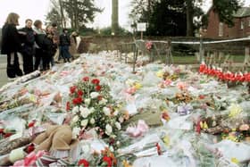 The flowers massed at the gates of Dunblane Primary School following the shooting of teacher Gwen Mayor and sixteen young children in 1996