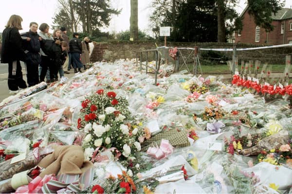 The flowers massed at the gates of Dunblane Primary School following the shooting of teacher Gwen Mayor and sixteen young children in 1996