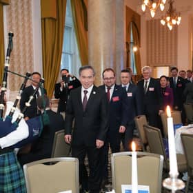Ren Hongbin is piped into the event at the Balmoral 
