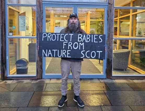 Activist protesting outside NatureScot building