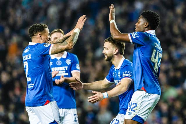 Rangers' Nicolas Raskin (C) celebrates with fellow goalscorers James Tavernier (L) and Tochi Chukwuani after a 4-1 win over Aberdeen.