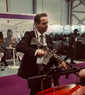UK immigration minister Mike Tapp holding a gun