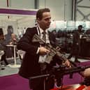 UK immigration minister Mike Tapp holding a gun
