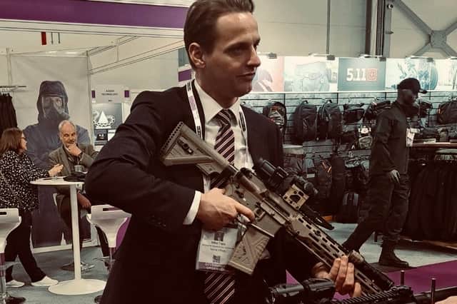UK immigration minister Mike Tapp holding a gun