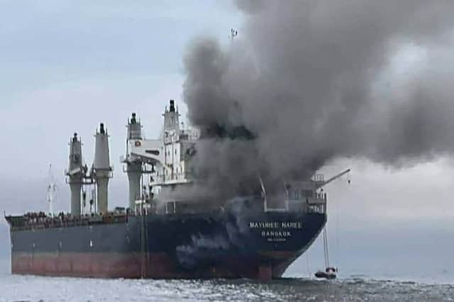 Smoke billows from the Thai bulk carrier Mayuree Naree near the Strait of Hormuz, which Iran has effectively closed to shipping, preventing supplies of oil from passing through (Picture: Royal Thai Navy)
